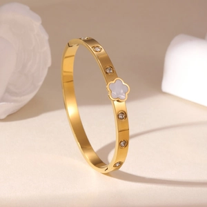 Bracciale rigido in acciaio dorato con fiore in madreperla e zirconi rotondi