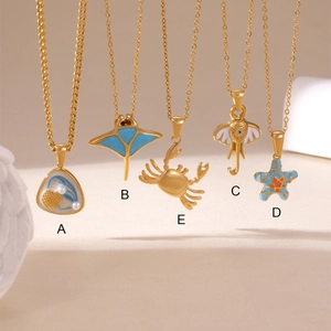 Detailed collection of five gold-plated ocean-themed necklaces with marine pendants
