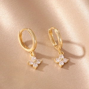 Elegant 14k gold plated flower drop earrings with clear zircons on champagne silk background
