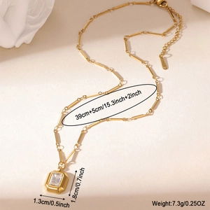 Detail of 18k gold plated necklace featuring square zircon pendant and paperclip chain links