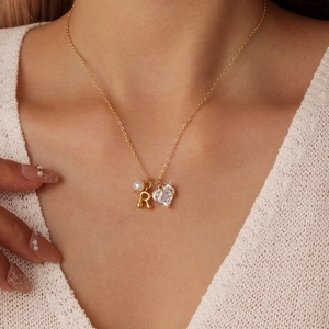 Gold stainless steel letter R necklace with heart zircon and pearl pendant on model