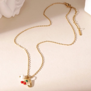 Detail of gold cherry and pearl necklace with a striped letter J pendant and lobster clasp