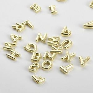 Macro shot of 14k gold-plated alphabet beads with side holes for DIY jewelry making
