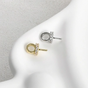 Macro shot of 14k gold and silver plated eye pins with micro-set zircon for DIY jewelry