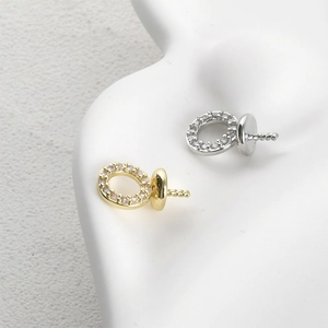 Close-up of gold and silver 14k plated round zircon cap pendants for DIY jewelry making