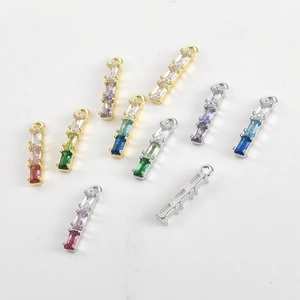 Macro detail of rectangle zircon charms with gold-plated bases for DIY jewelry making