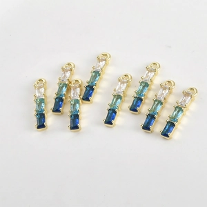 Macro detail of 14k gold-plated bamboo pendants with gradient zircon stones for DIY jewelry