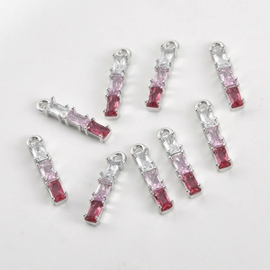 Detail of nine bamboo joint pendants with pink gradient zircon stones in silver plating