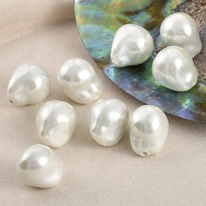 Macro shot of irregular baroque faux pearls with iridescent luster for DIY jewelry making