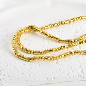 Detailed macro view of 4mm gold plated lava stone beads for DIY jewelry making