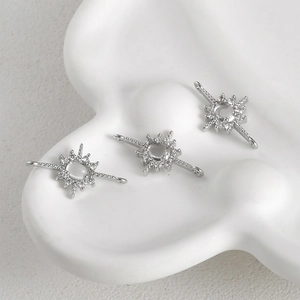 Macro detail of silver starburst connectors with cubic zirconia for DIY jewelry making