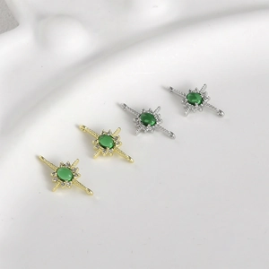 Detailed view of 14k gold-filled starburst connector with green stone for DIY jewelry