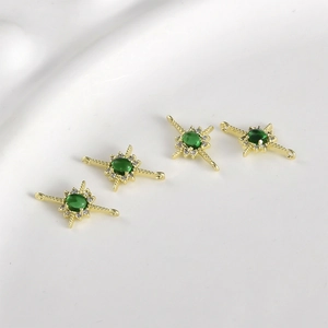 Detail of 14k gold-filled cross star connectors with green gemstones and zircons