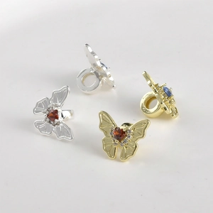 Golden and silver butterfly jewelry charms with zircon heart gemstones and crystal accents
