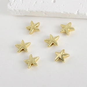 Close-up of 14k gold plated starfish spacer beads with textured finish for jewelry making