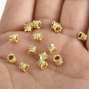 Close-up of 14k gold plated lace flower spacer beads for DIY jewelry making