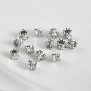 Macro detail of silver plated hollow flower spacer beads for DIY jewelry making