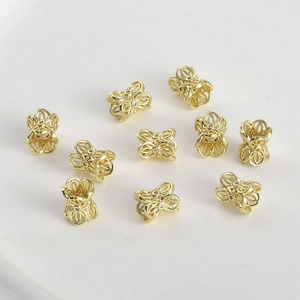Macro detail of 10-piece gold plated hollow butterfly beads for DIY jewelry making