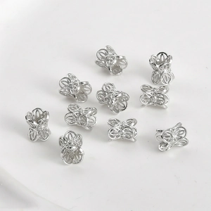 Detailed view of silver lace hollow flower beads for DIY handmade jewelry crafts