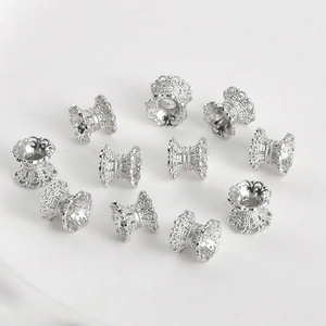 Detailed view of silver lace hollow spacer beads for DIY jewelry making and necklace crafts