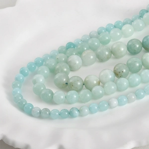 Macro shot of 8mm natural Persian jade round beads with blue and green mineral textures