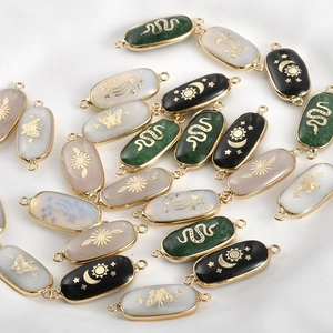 Oval natural stone pendants with gold embossed celestial motifs for DIY jewelry making