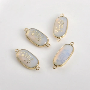 Set of four oval gold-rimmed connectors with white opal finish and star patterns