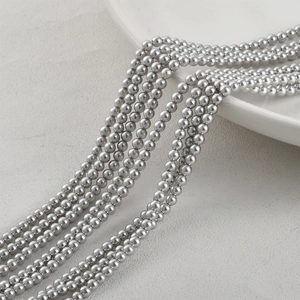 Macro view of metallic silver round glass beads with high mirror finish for DIY jewelry