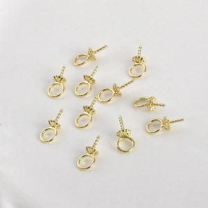 Macro shot of 14k gold plated flower shaped bail pins for DIY pearl jewelry making
