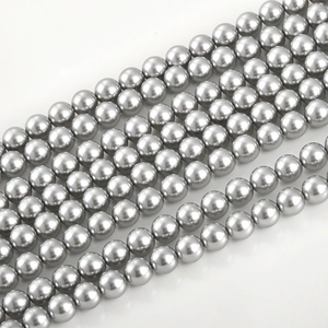 Macro shot of silver gray glass pearl beads with high metallic luster for DIY jewelry