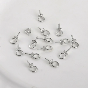 Macro detail of 14k gold plated flower shaped bail pins for DIY pearl pendant making