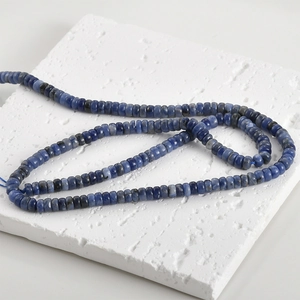 Macro view of blue natural gemstone abacus beads with unique white textures