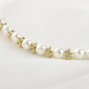 Detailed view of 14k gold plated bow spacer bead with zircons for DIY jewelry making