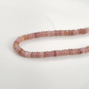 Macro shot of natural pink crystal abacus beads with smooth polished finish and translucent texture