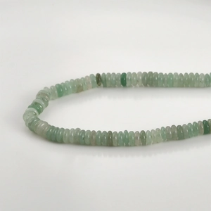 Macro detail of natural green jade abacus beads showing smooth polished texture and gradient