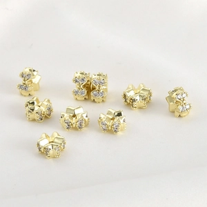 Detailed macro of 14k gold plated bow knot beads with micro-set cubic zirconia for DIY jewelry