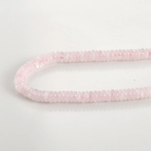 Close-up of pink translucent natural stone flat beads for DIY jewelry making