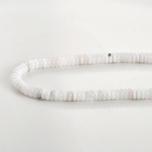 Macro shot of 2x6mm white natural stone spacer beads for DIY jewelry making