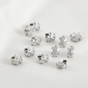 Macro shot of silver bow beads with cubic zirconia for DIY jewelry making and crafts