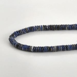 Macro shot of natural Sodalite stone abacus beads showing deep blue mineral textures