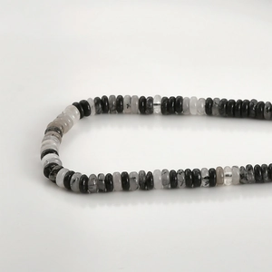 Macro detail of natural black rutilated quartz abacus beads for DIY jewelry making