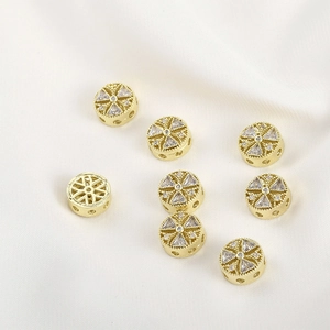 Macro detail of 14k gold plated round spacer beads with white cubic zirconia for DIY jewelry
