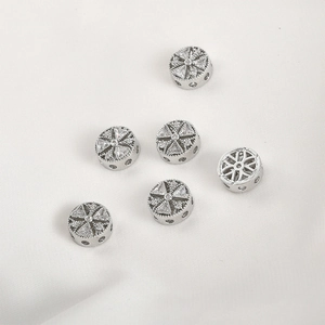 Close-up of 14k gold-plated circular spacer beads with sparkling zircon inlay for DIY jewelry