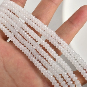 Macro shot of 2x4mm translucent white glass rondelle spacer beads for DIY jewelry making