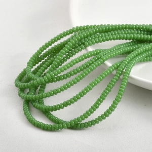 Detailed view of 2x4mm glossy green glass spacer beads for DIY jewelry making