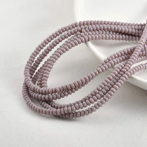 Detailed macro shot of 2x4mm lavender glass spacer beads for DIY jewelry making