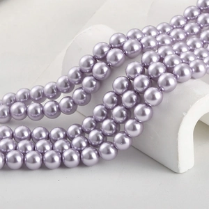 Lustrous grape purple glass pearls on white geometric stand for DIY jewelry making