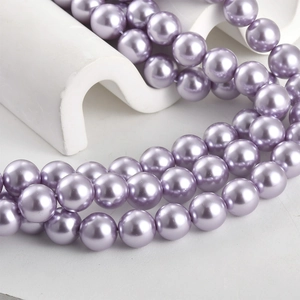 Macro shot of 8-10mm lilac purple pearl beads for DIY jewelry making on white background