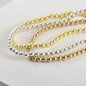 Macro shot of 6-10mm gold, silver, and rose gold hematite beads with mirror finish