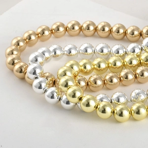 Close-up of gold and silver plated hematite round beads for DIY jewelry making